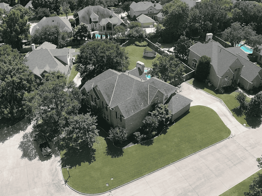 Aerial view of a newly installed residential roof by Upright Roofing & Construction in Dallas, TX.